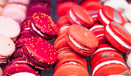 bright cakes and macaroons in the bakery windowの写真素材