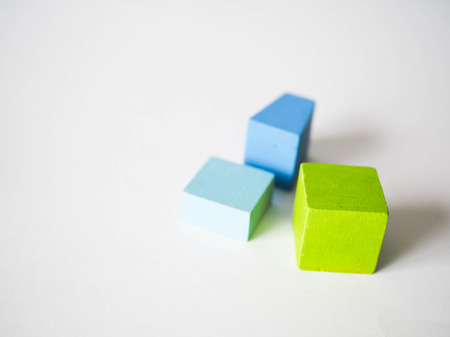 colored children's cubes lie on a white backgroundの写真素材