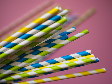 bright paper straws on a bright background . Summer backgroundの写真素材