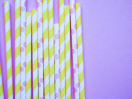 bright paper straws on a bright background . Summer background