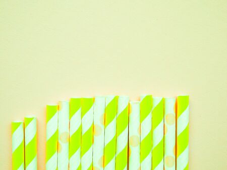 bright paper straws for a cocktail on a bright background . Summer backgroundの写真素材