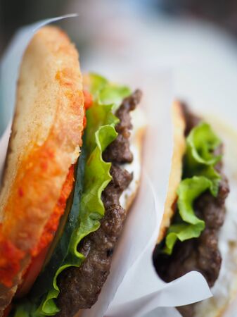 very big hamburger in his hand. fast foodの写真素材