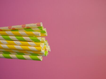 bright paper straws for a cocktail on a bright background . Summer backgroundの写真素材