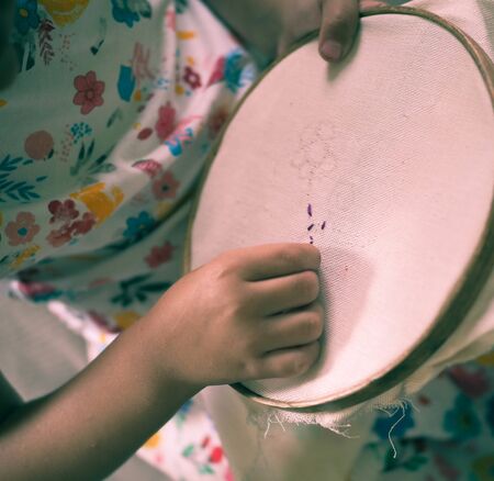 little girl learn to embroider needlework herselfの写真素材