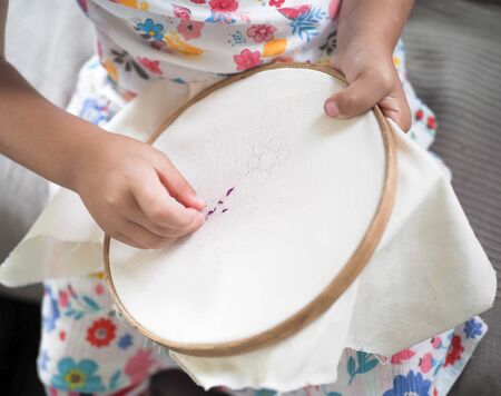 little girl learn to embroider needlework herselfの写真素材