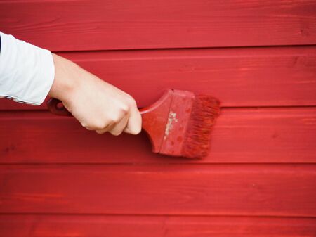 old paint brush on wood background paintingの写真素材
