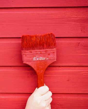 old paint brush on wood background paintingの写真素材