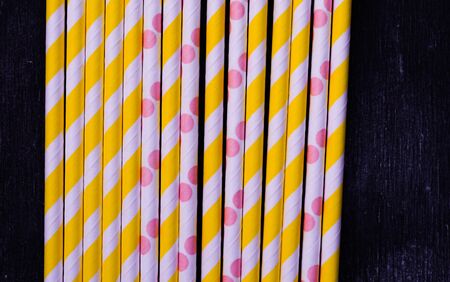bright paper straws for a cocktail on a bright background . Summer backgroundの写真素材