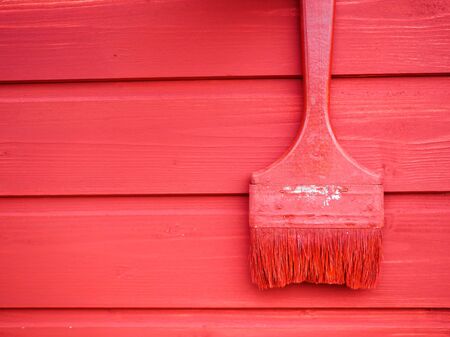 old paint brush on wood background paintingの写真素材