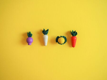 wooden toy vegetables on a colored background conceptの写真素材