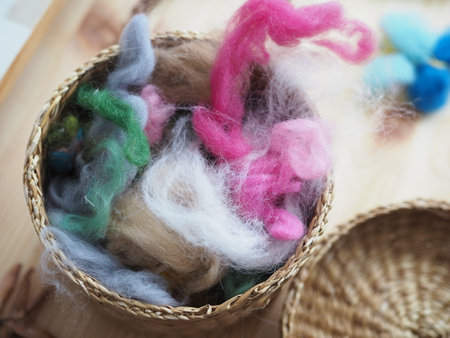 small basket with a set of colored wool for felting handcraftの写真素材