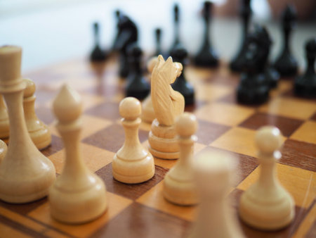 Wooden chess with blurred background. chess board with figures close-up High quality photoの写真素材