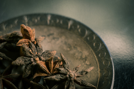 Spices. Anise stars photo. Intentionally blurred lens focus effect. Color toning. Closeup.の写真素材