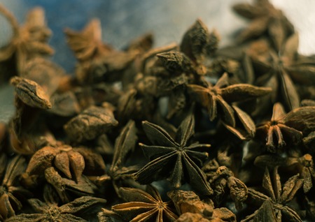 Spices. Anise stars photo. Intentionally blurred lens focus effect. Color toning. Closeup.の写真素材