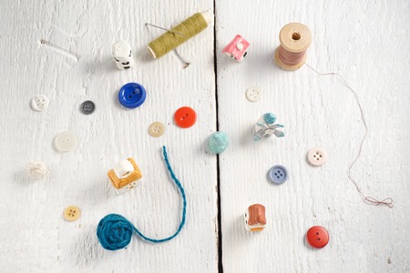 Sewing tools on white wood background photo.の写真素材