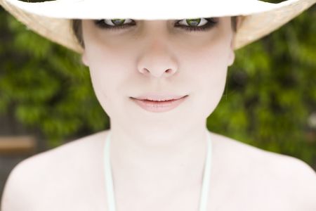 Eyes Under The Hat. Model Woman Relaxing Outdoors.の写真素材