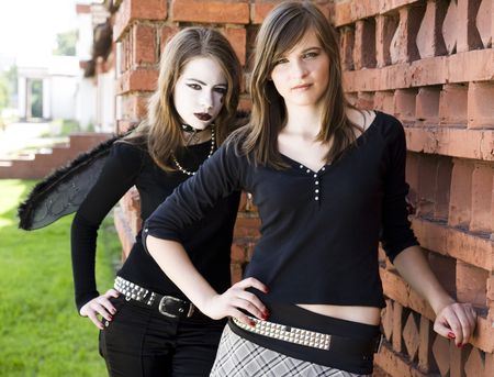 Two Teenager Girls Near The Brick Wallの写真素材