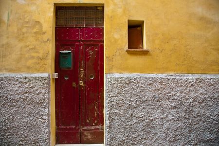 Red Door and Yellow Wall. Old Italy Series.の写真素材