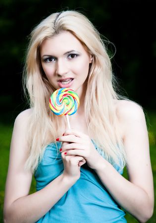 Girl And Her Lollipop On The Nature Backgroundの写真素材