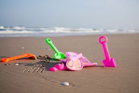 Colorful children toys on the beach. Childhood collection.の写真素材