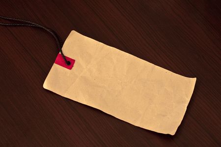Empty price tag on wooden background