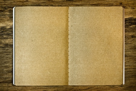 Blank brown notepad on the wood backgroundの写真素材