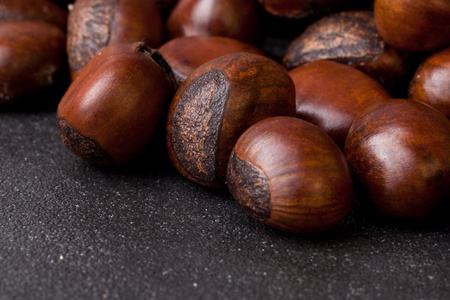 Roasted chestnut on dark stone backgroundの写真素材