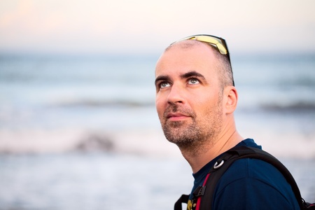 Young man walking at beachの写真素材