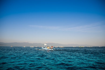 Fisherman boats with Bali island on backgroundの写真素材