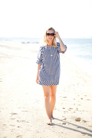 Young adult woman walking along a beachの写真素材