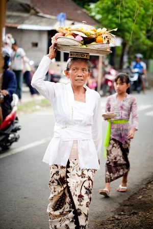 GIANYAR, BALI, INDONESIA- MAY 21: Unidentified villagers bring gifts to the gods at the Balinese Temple during the Odalan Festival on May 21, 2011 in Gianyar, Bali, Indonesia. のeditorial素材