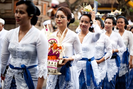 GIANYAR, BALI, INDONESIA- MAY 21: Unidentified villagers bring gifts to the gods at the Balinese...
