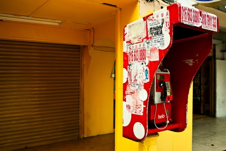 KUALA LUMPUR - NOVEMBER 29: Public phone box on the street. November 29, 2011 in Kuala Lumpur,...