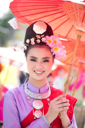 CHIANG MAI, THAILAND - FEBRUARY 4: Traditionally dressed woman in procession on Chiang Mai 36th Flower Festival on February 4, 2012 in Chiang Mai, Thailandのeditorial素材