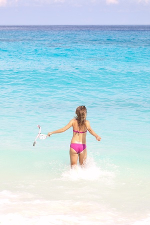 Snorkel Woman Running at the Tropical Beachの写真素材