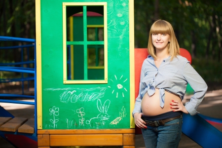 Beautiful Pregnant woman on the playground の写真素材