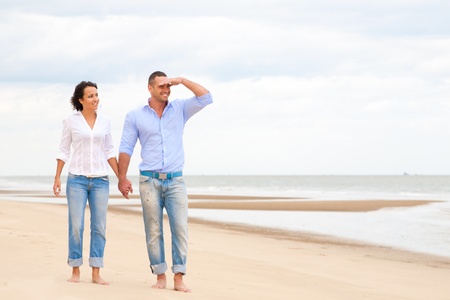 Portrait of a happy couple at the beachの写真素材