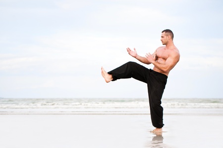 Man training karate at the beachの写真素材