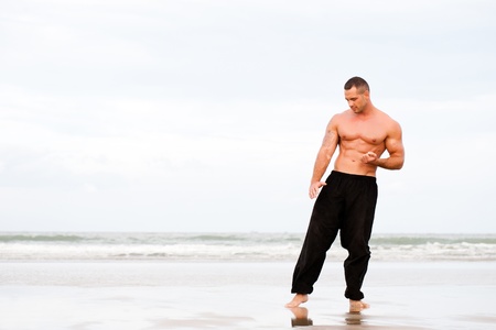 Man training karate at the beachの写真素材