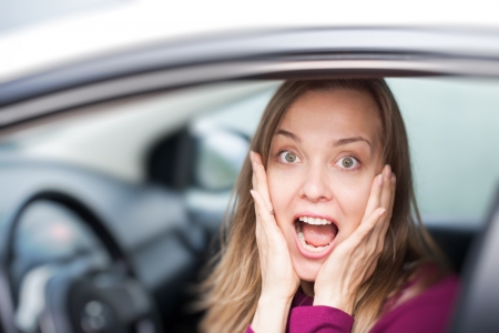 Shocked woman in a carの写真素材