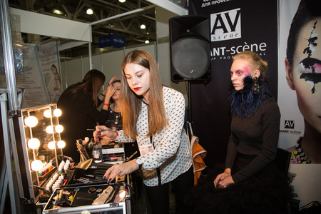 MOSCOW - OCTOBER 24: Cosmetologist applying permanent make up on lips at the international exhibition of professional cosmetics and beauty salon equipment INTERCHARM on October 24; 2014 in Moscowのeditorial素材