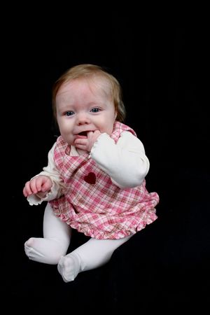 Cute little girl on a black backgroundの写真素材