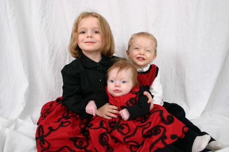 Three adorable kids sitting together, familyの写真素材