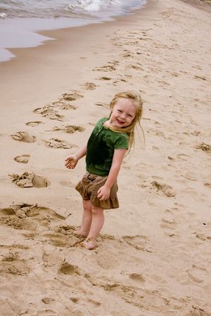 Little Girl playing at the beach in the summer timeの写真素材