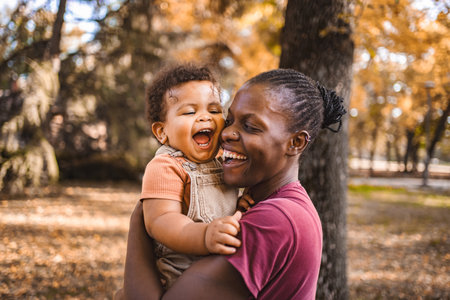 Mothers Embrace: Joyful Moments in the Parkの写真素材