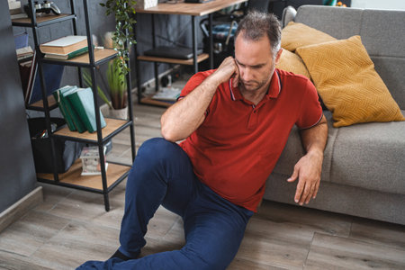Alone man sitting on ground looking sad and distraught