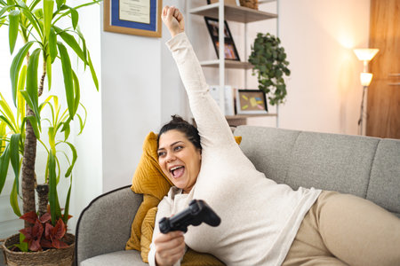 Woman having fun playing video games at home