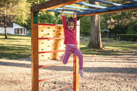 Active cute little girl on the playground
