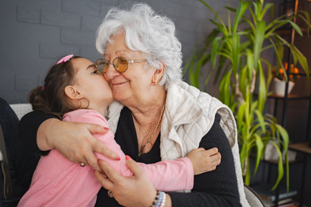 Grandma and granddaughter share a cozy momentの写真素材