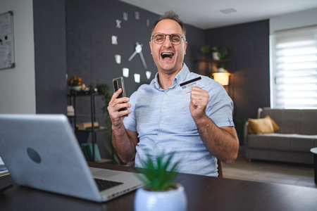 Middle aged Caucasian man online shopping at home
